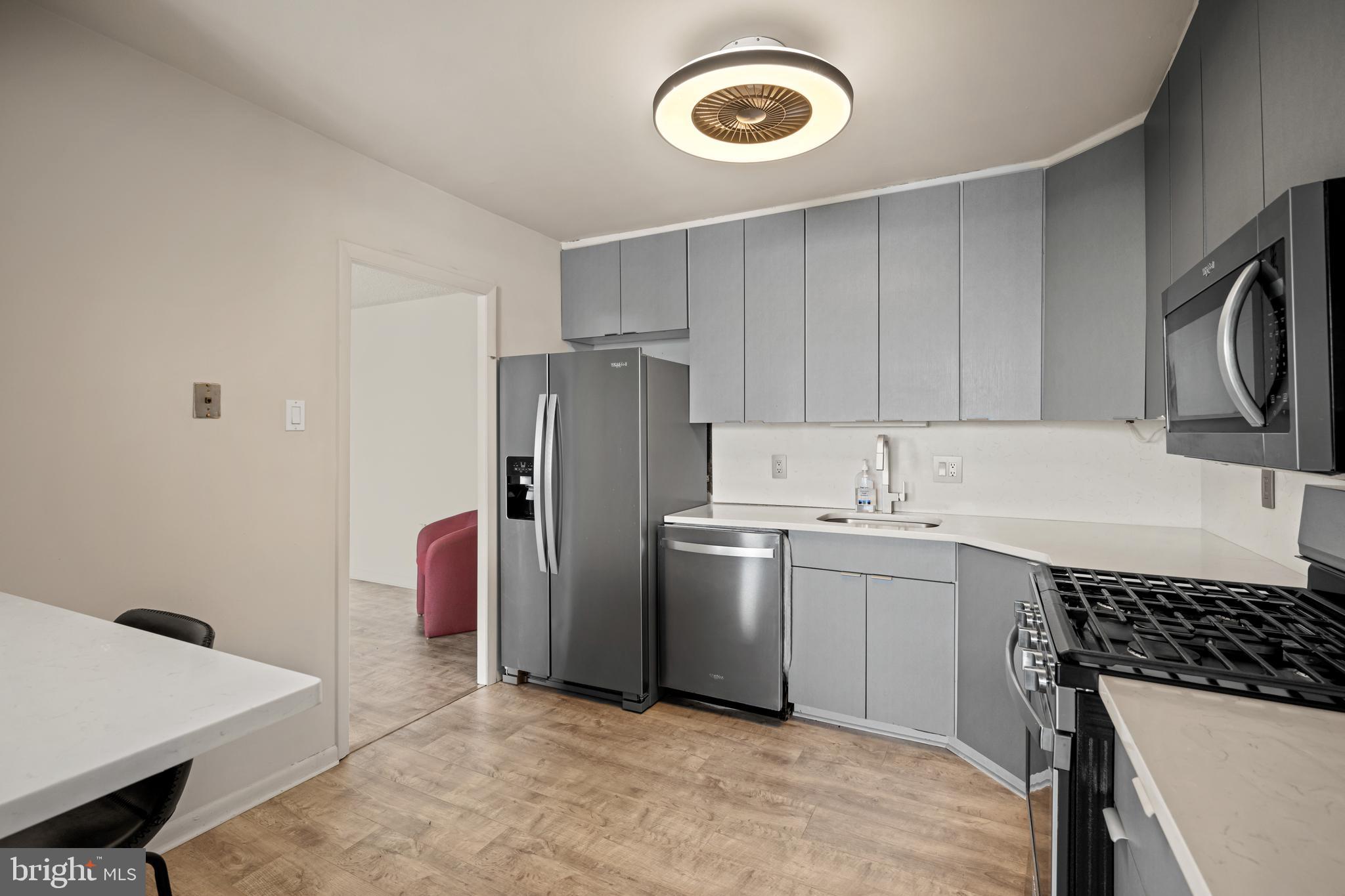 1840 Frontage Road, Unit 1501 Cherry Hill, NJ 08034 - Photo 3 of 20 a kitchen with a sink a stove top oven and refrigerator