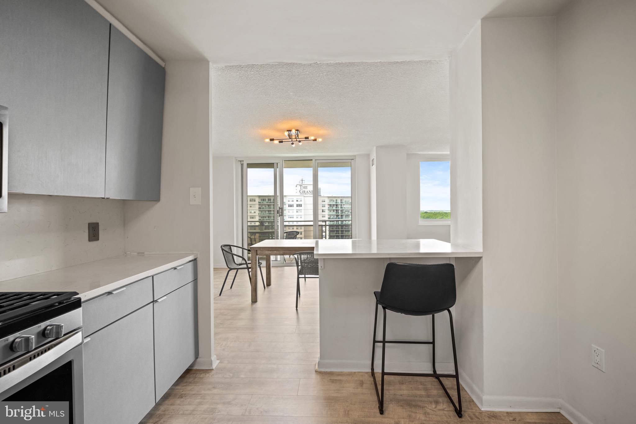 1840 Frontage Road, Unit 1501 Cherry Hill, NJ 08034 - Photo 5 of 20 a kitchen with a table chairs stove and cabinets