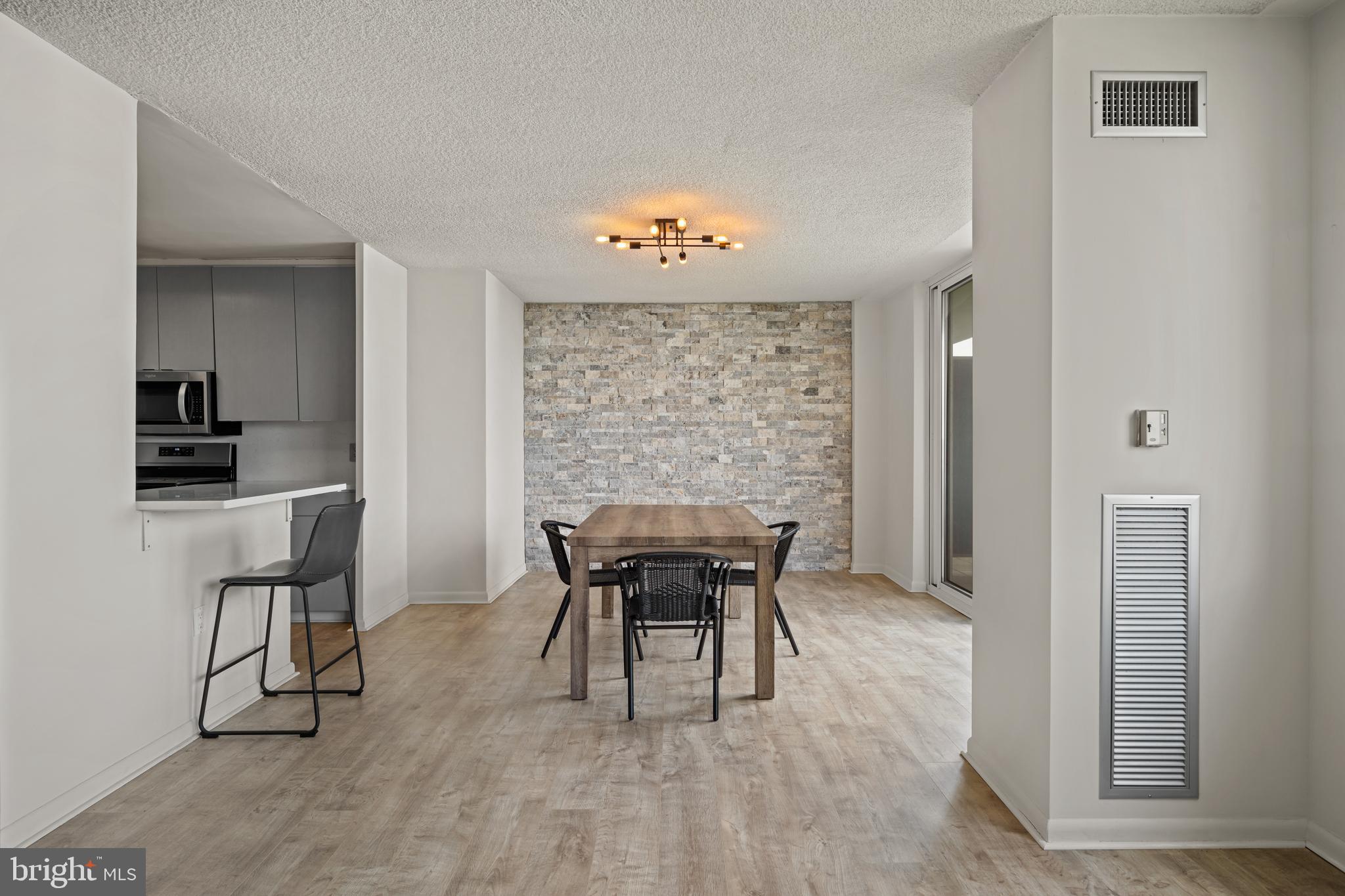 1840 Frontage Road, Unit 1501 Cherry Hill, NJ 08034 - Photo 9 of 20 a dining room with furniture a chandelier and wooden floor