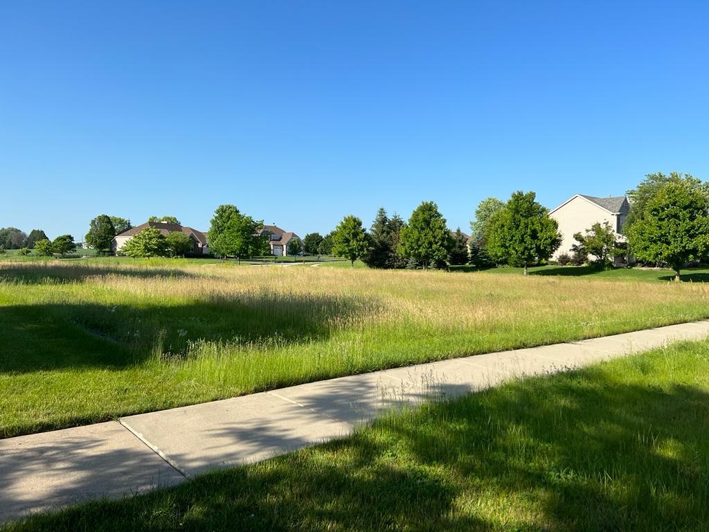 2148 Bartram Road North Aurora, IL 60542 - Photo 2 of 12 a view of a lake with a big yard and large trees