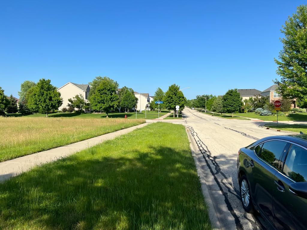 2148 Bartram Road North Aurora, IL 60542 - Photo 3 of 12 a view of a garden with a lake
