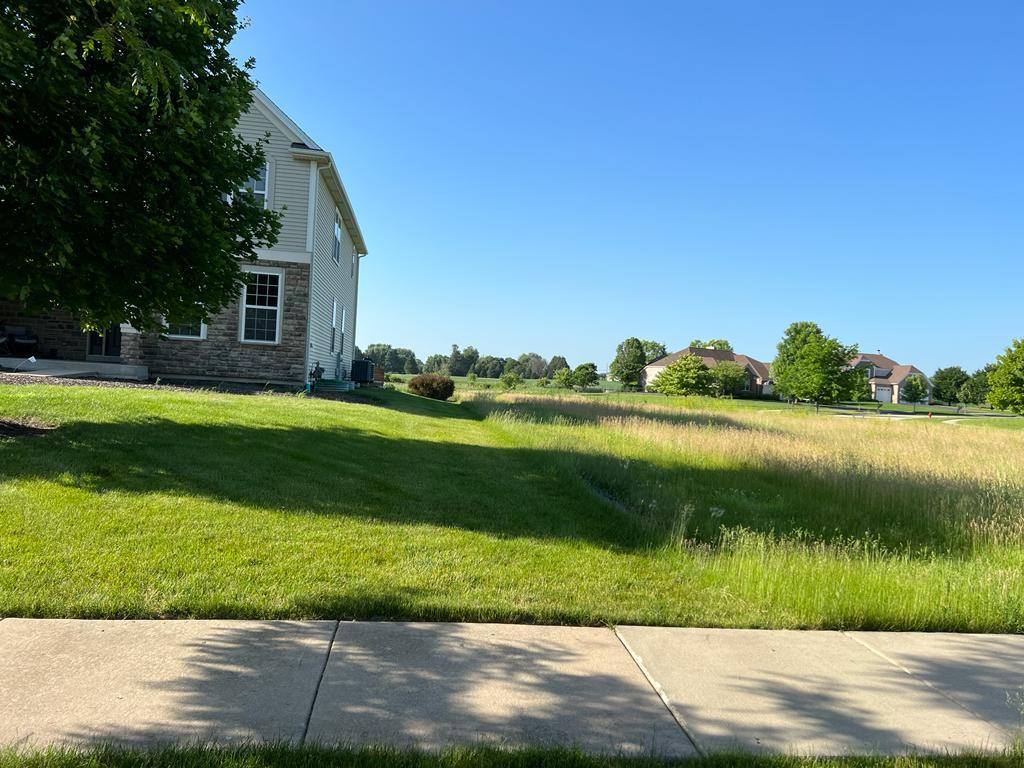 2148 Bartram Road North Aurora, IL 60542 - Photo 4 of 12 a view of a lake with a big yard