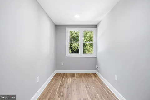 a view of room with window and hardwood floor
