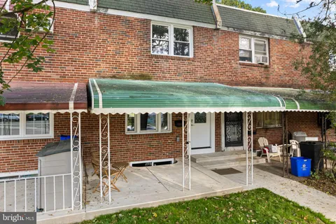 a view of a patio with table and chairs and potted plants