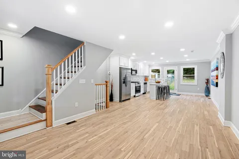 a view of a hall with wooden floor and dining room