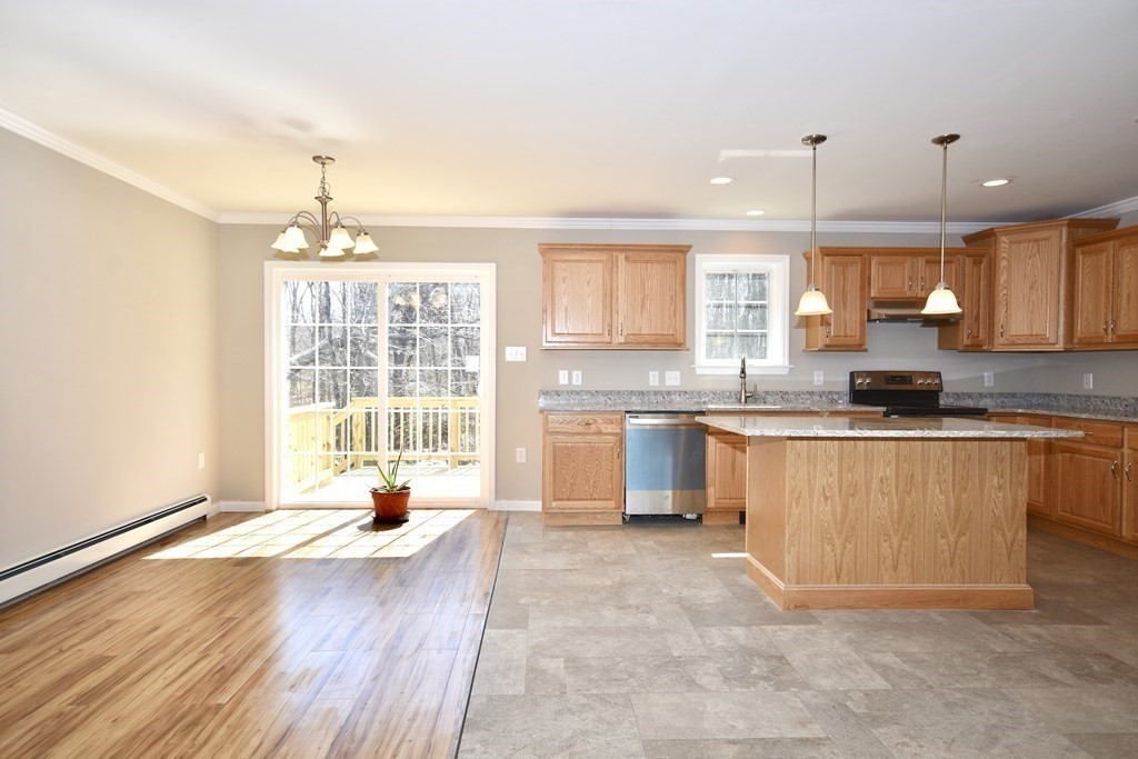 5 Woodlawn Road Freetown, MA 02702 - Photo 11 of 24 a large kitchen with kitchen island a large counter space a sink appliances and cabinets