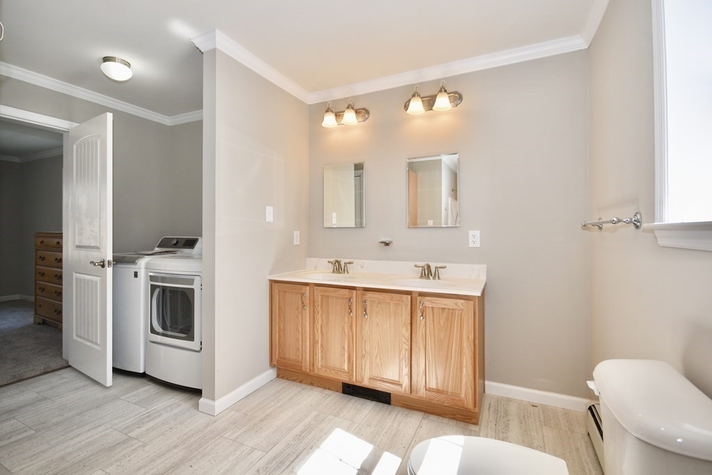 5 Woodlawn Road Freetown, MA 02702 - Photo 14 of 24 a bathroom with a sink a toilet and mirror
