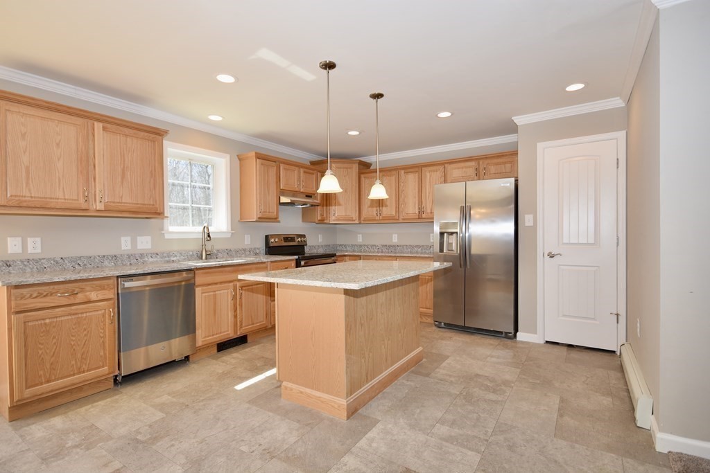 5 Woodlawn Road Freetown, MA 02702 - Photo 8 of 24 a kitchen with stainless steel appliances granite countertop a sink a stove a refrigerator a center island and a window