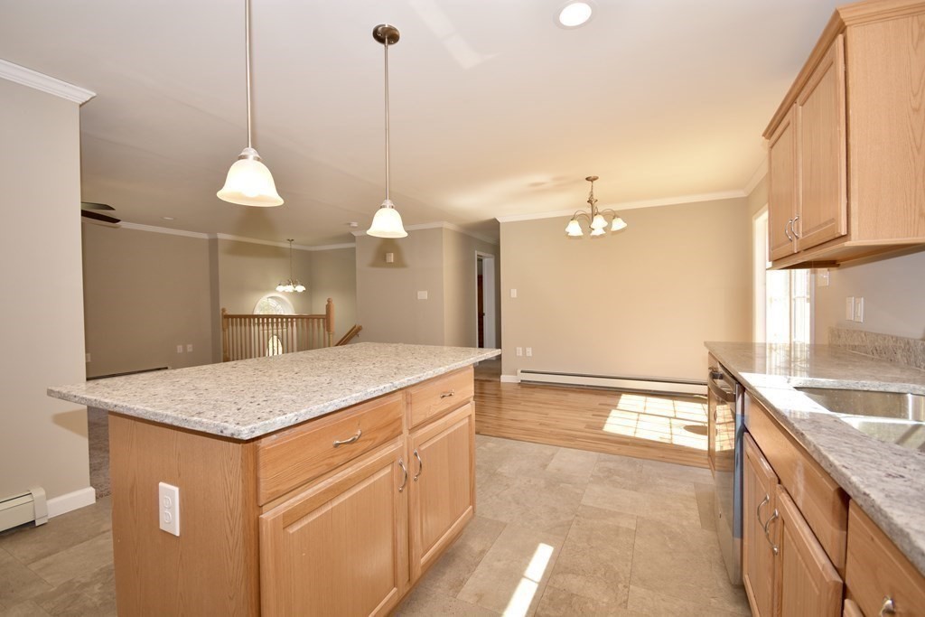 5 Woodlawn Road Freetown, MA 02702 - Photo 10 of 24 a kitchen with a sink a faucet a chandelier and living room view