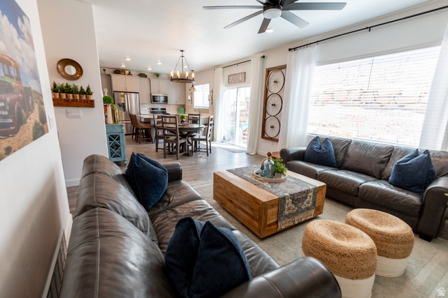 1373 South Raintree Lane Santaquin, UT 84655 - Photo 4 of 29 Living room featuring light wood-style flooring, suspended lighting, and a ceiling fan