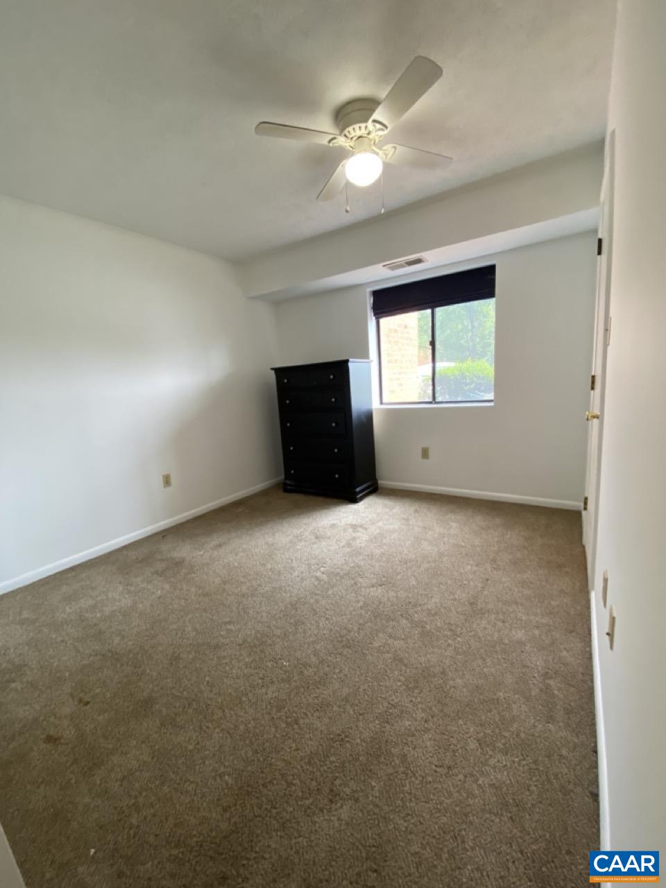 102 Turtle Creek Road, Unit 1 Charlottesville, VA 22901 - Photo 13 of 26 en empty room with windows and ceiling fan