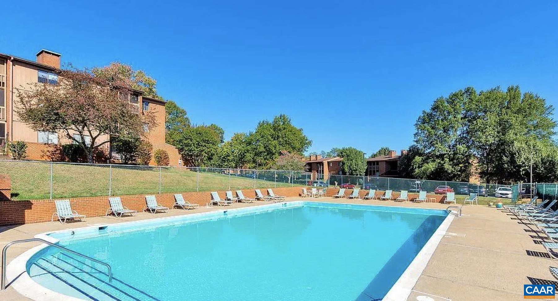 102 Turtle Creek Road, Unit 1 Charlottesville, VA 22901 - Photo 25 of 26 a view of a swimming pool with a bench and trees