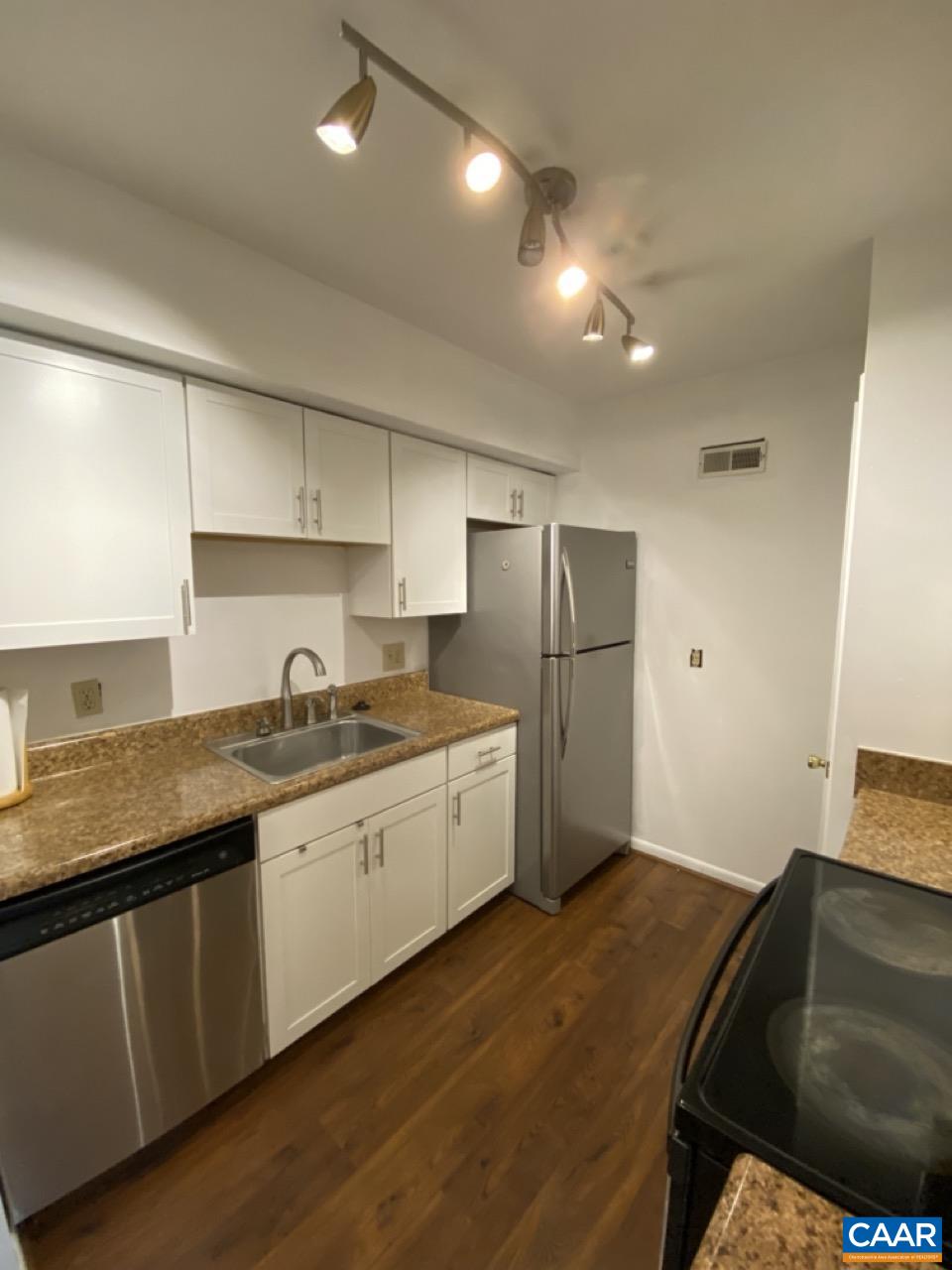 102 Turtle Creek Road, Unit 1 Charlottesville, VA 22901 - Photo 8 of 26 a kitchen with granite countertop a sink a refrigerator and a stove