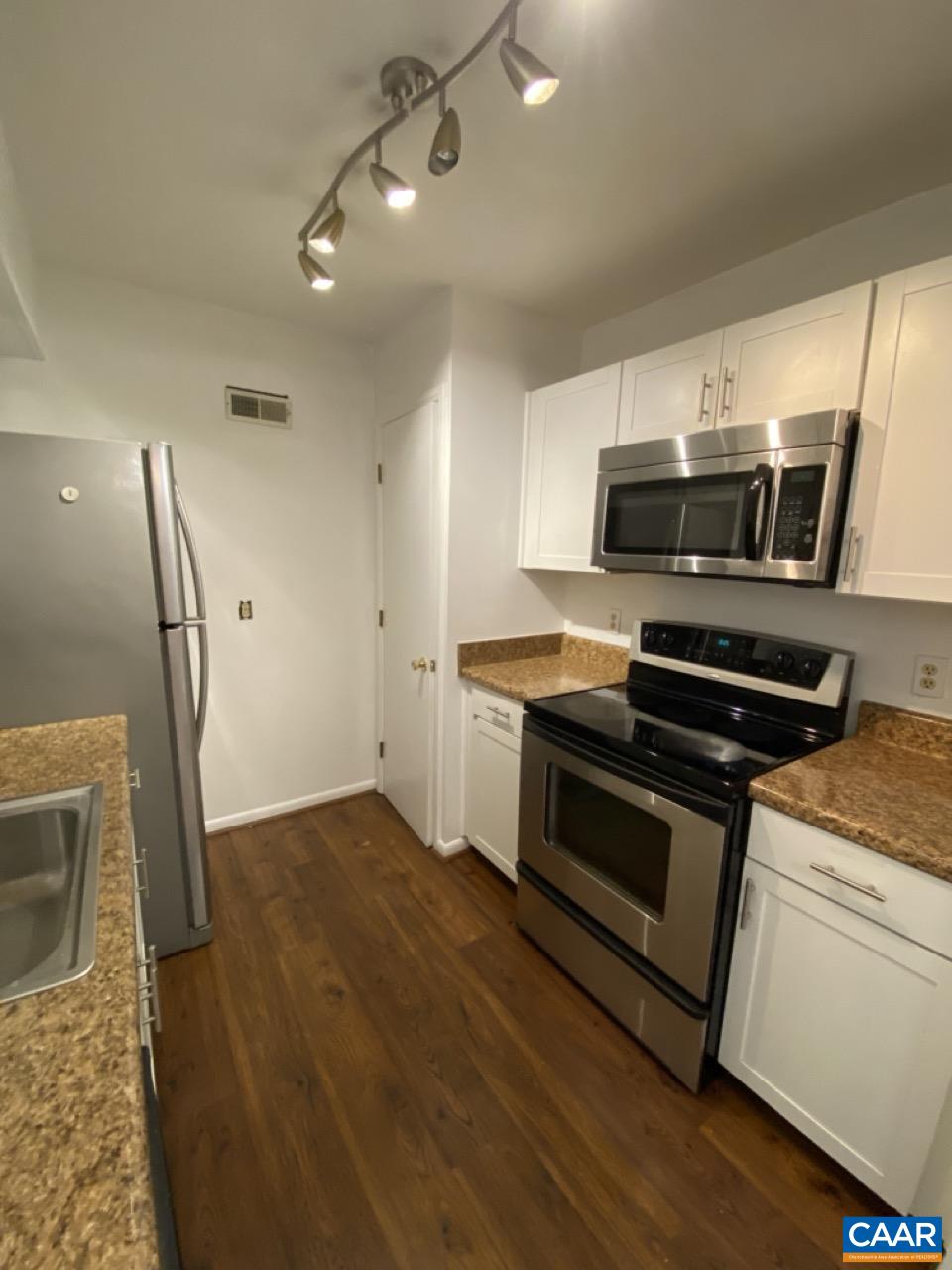 102 Turtle Creek Road, Unit 1 Charlottesville, VA 22901 - Photo 9 of 26 a kitchen with a stove and a microwave