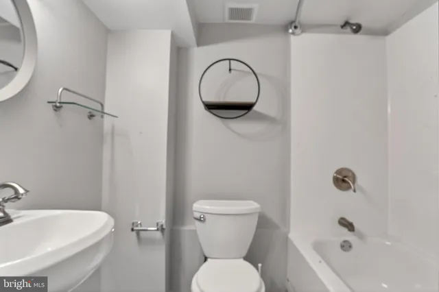 a bathroom with a toilet and a sink