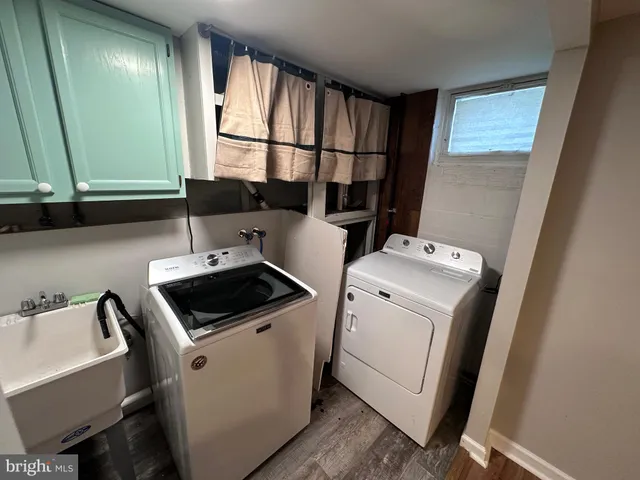 a view of storage and utility room with washer and dryer
