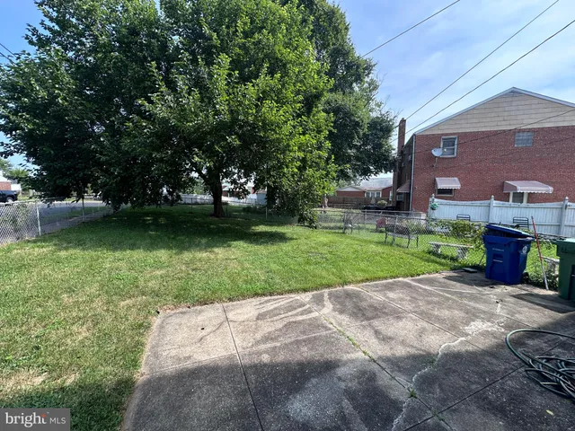a view of a house with a backyard and a garden