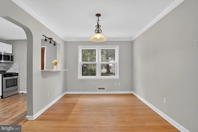a view of livingroom with window wooden floor and front door