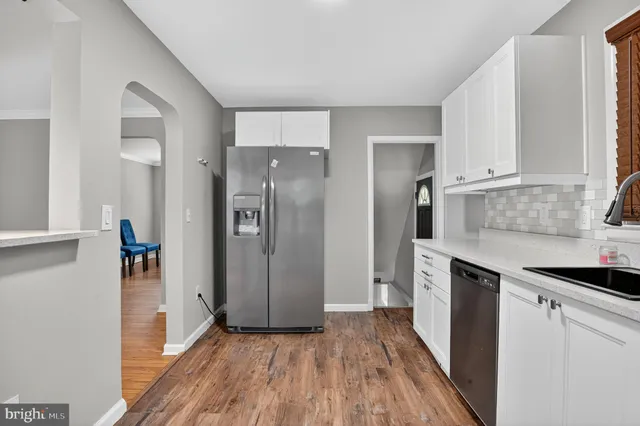 a kitchen with stainless steel appliances a refrigerator and a stove top oven