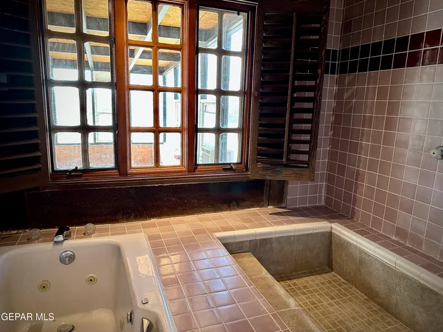 a bedroom with furniture and a fireplace