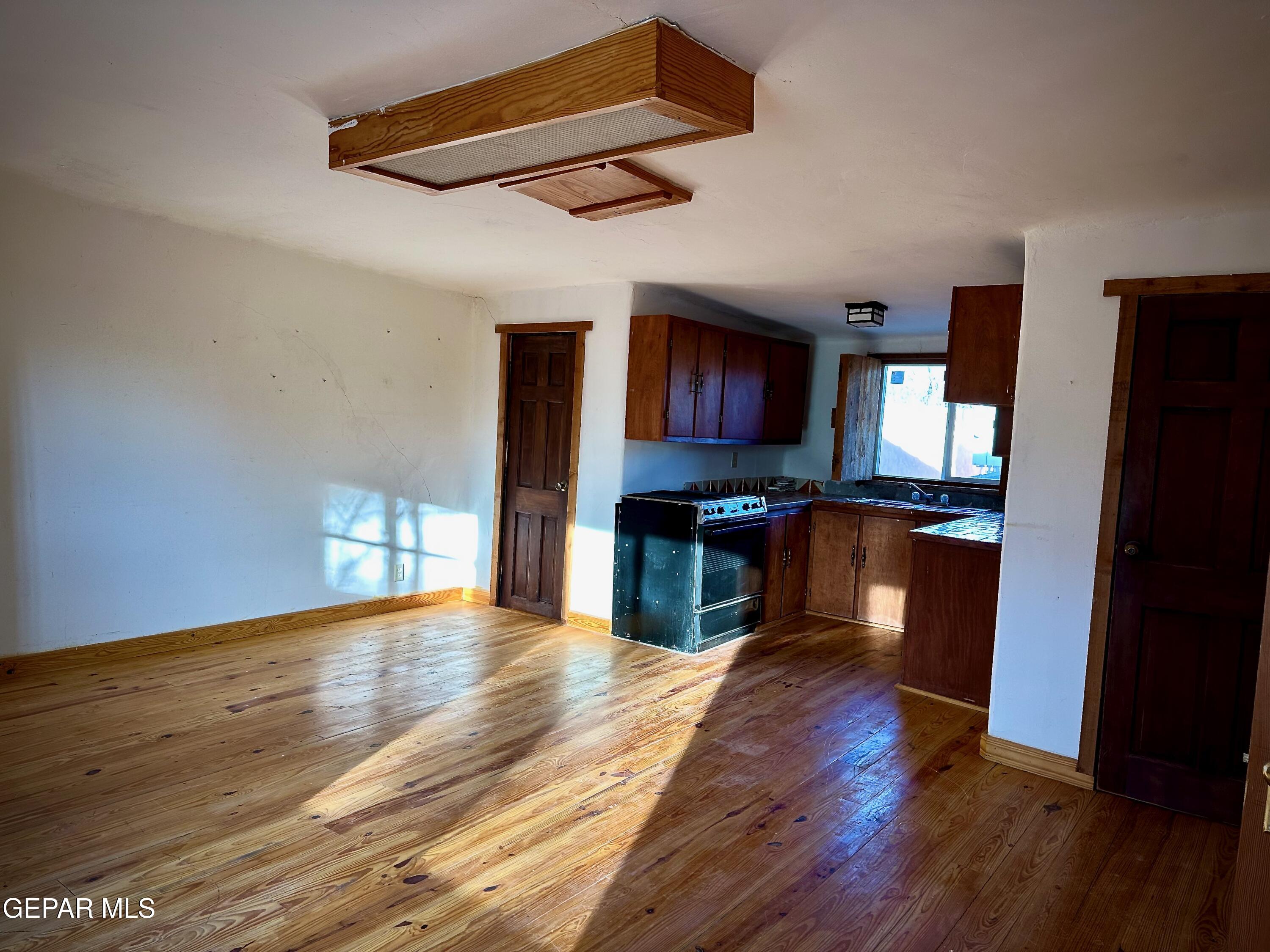 1095 Little Road Anthony, NM 88021 - Photo 18 of 30 a kitchen view with wooden floor counter top space and stainless steel appliances