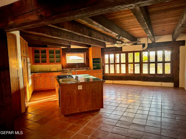 a kitchen with stainless steel appliances a sink stove and cabinets