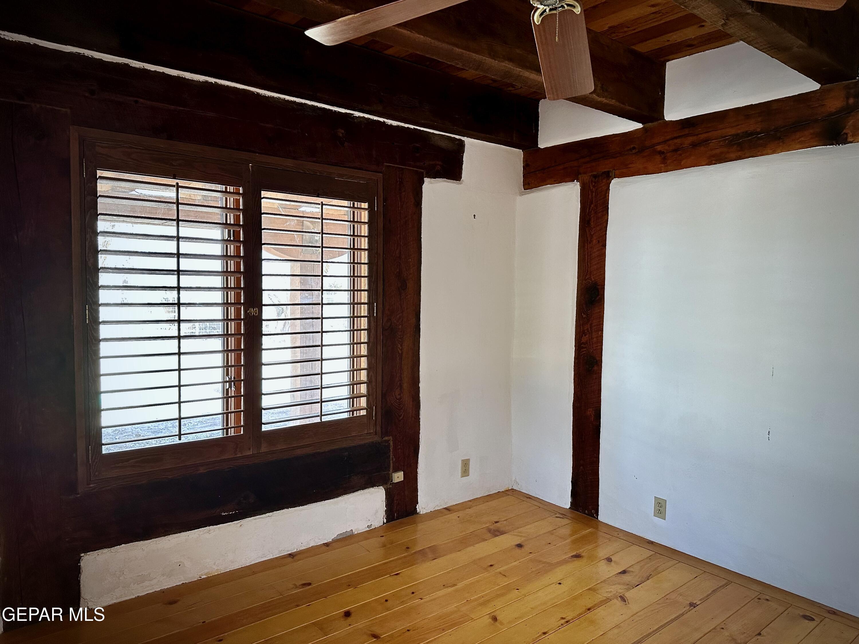 1095 Little Road Anthony, NM 88021 - Photo 8 of 30 a view of an empty room with wooden floor and a window