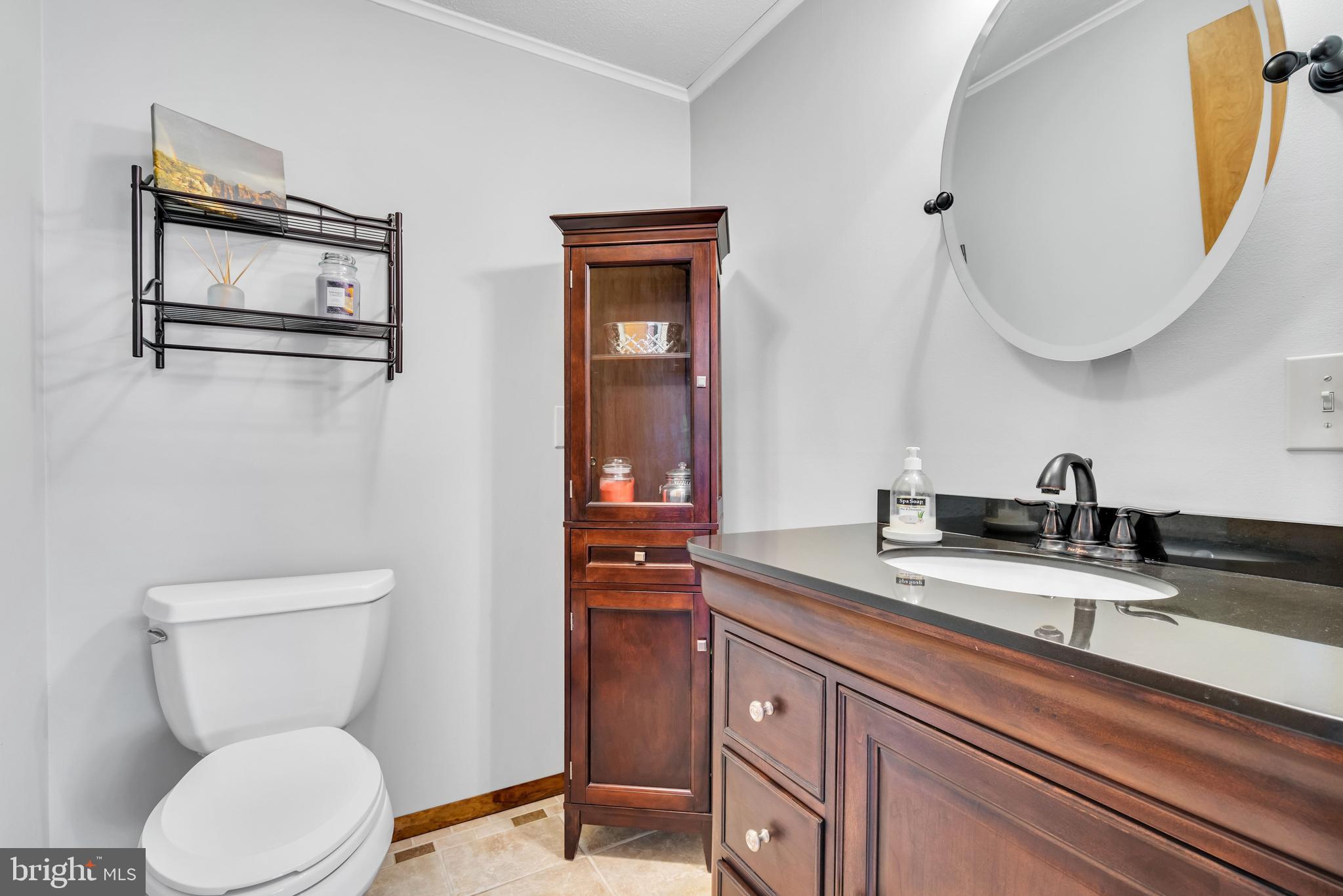 33 Poplar Street Sicklerville, NJ 08081 - Photo 15 of 62 a bathroom with a toilet a sink and mirror