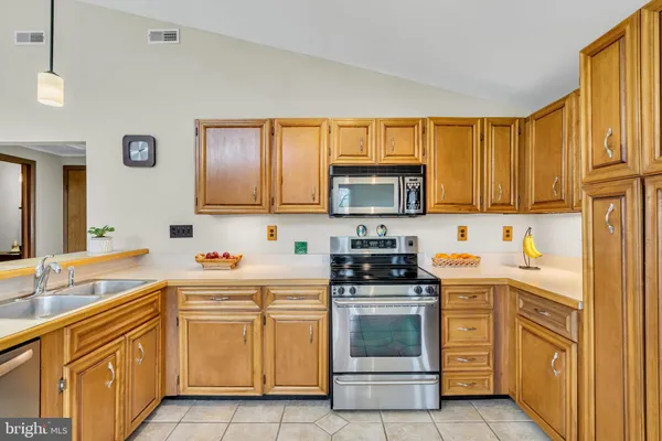 a kitchen with refrigerator cabinets and chairs