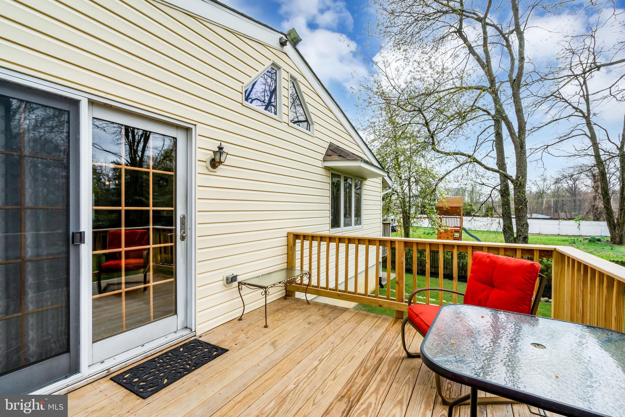 33 Poplar Street Sicklerville, NJ 08081 - Photo 50 of 62 a view of a deck with couches table and chairs and wooden floor
