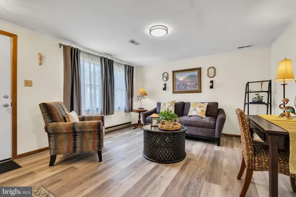 a view of a dining room with furniture window and wooden floor