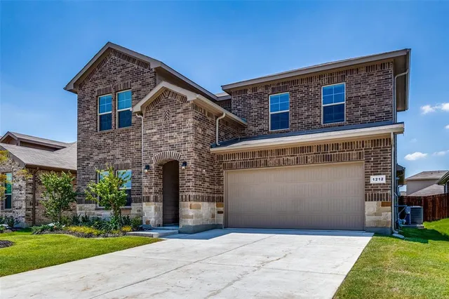 a front view of a house with a garden and plants