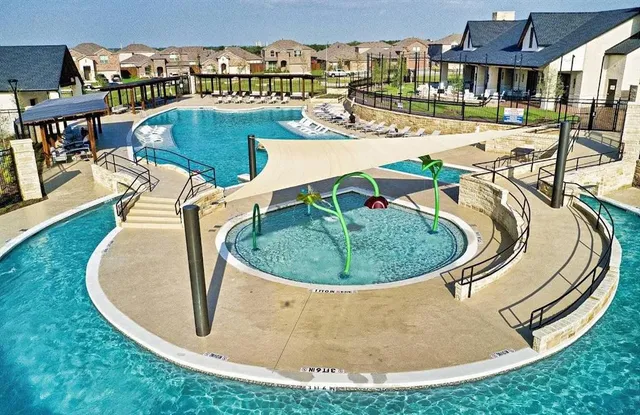 a view of a swimming pool with outdoor seating
