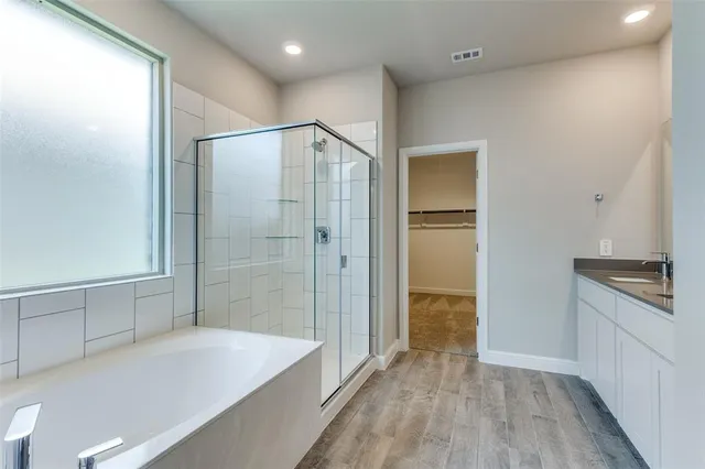 a bathroom with a bathtub and a shower