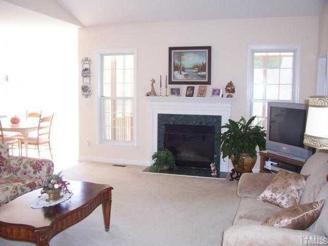 1133 Loop Road Clayton, NC 27527 - Photo 3 of 12 Huge family room with cathedral ceiling. Beautiful fireplace with marble hearth is focal point.