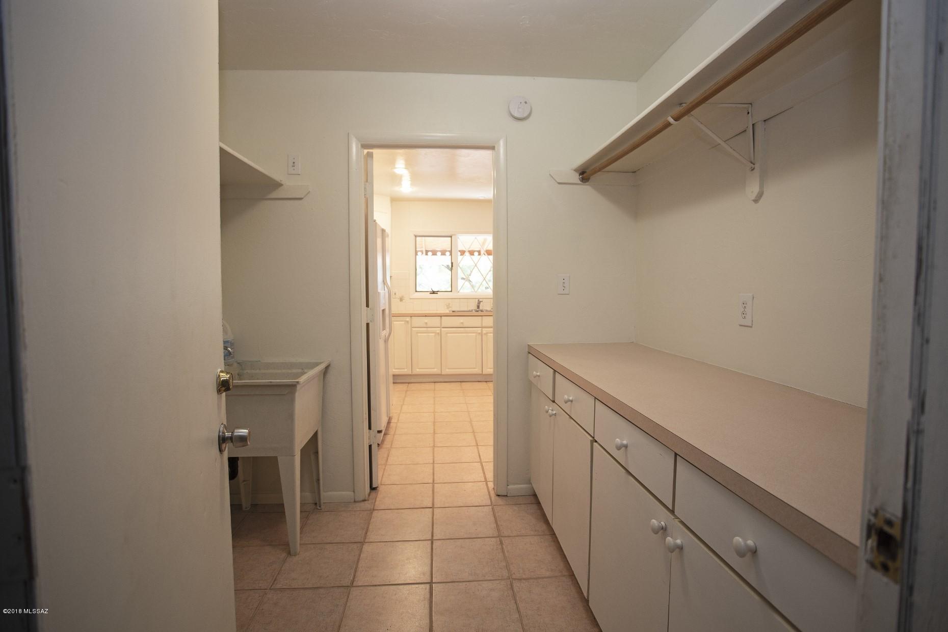 5851 South Avra Road Tucson, AZ 85735 - Photo 23 of 46 a view of cabinets and utility room with closet