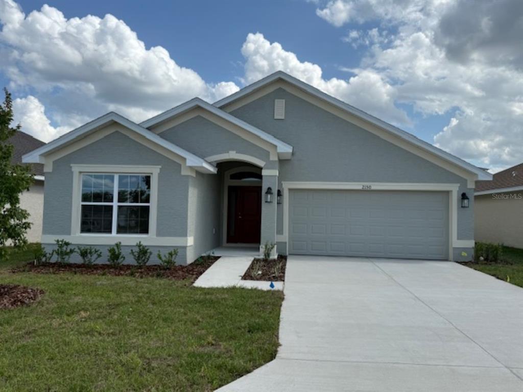 2150 Northwest 23rd Loop Ocala, FL 34475 - Photo 1 of 19 a front view of a house with a yard