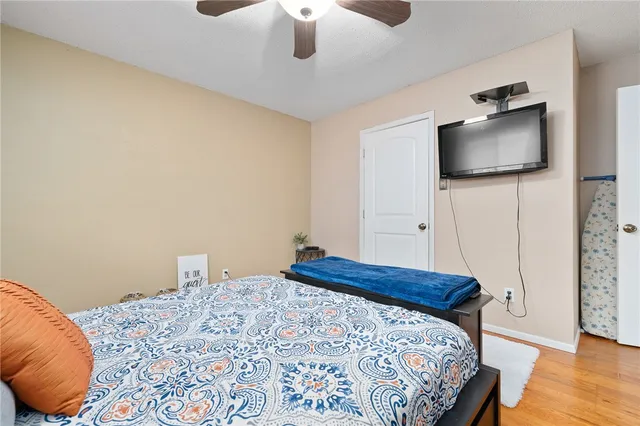 a bedroom with a bed and a flat screen tv