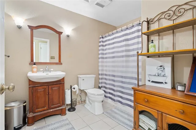 a bathroom with a sink a toilet and mirror