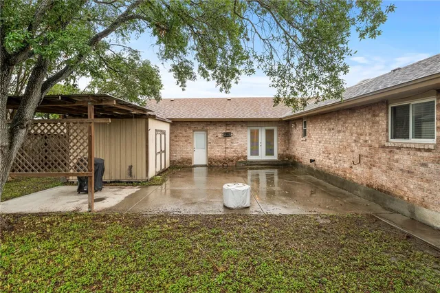 a front view of a house with a yard garage and chair
