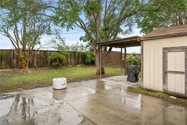 a view of a house with backyard and sitting area
