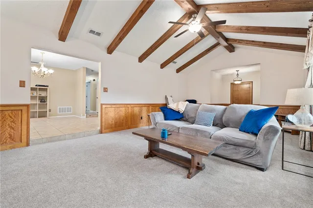 a living room with furniture and a ceiling fan