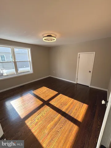 a view of a livingroom with wooden floor and a window