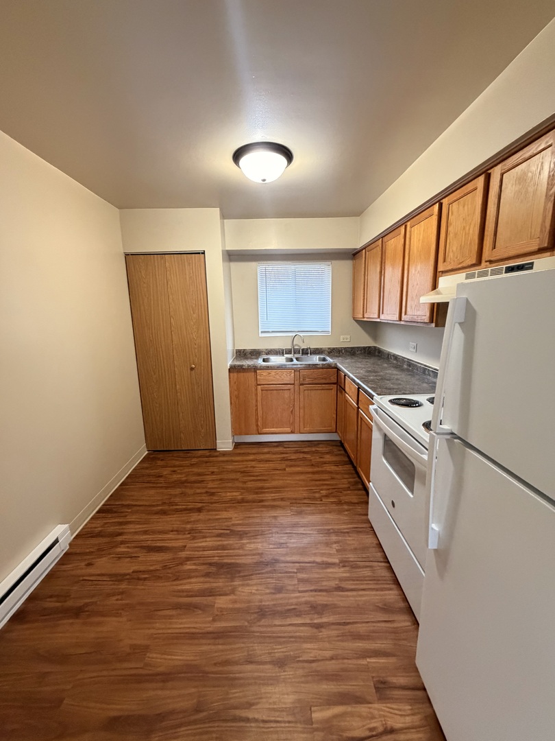 25731 West Bridge Street, Unit 3 Channahon, IL 60410 - Photo 2 of 7 a kitchen with granite countertop a refrigerator stove top oven and sink