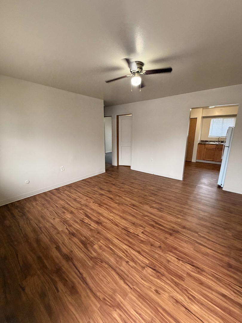 25731 West Bridge Street, Unit 3 Channahon, IL 60410 - Photo 4 of 7 a big room with wooden floor closet and windows