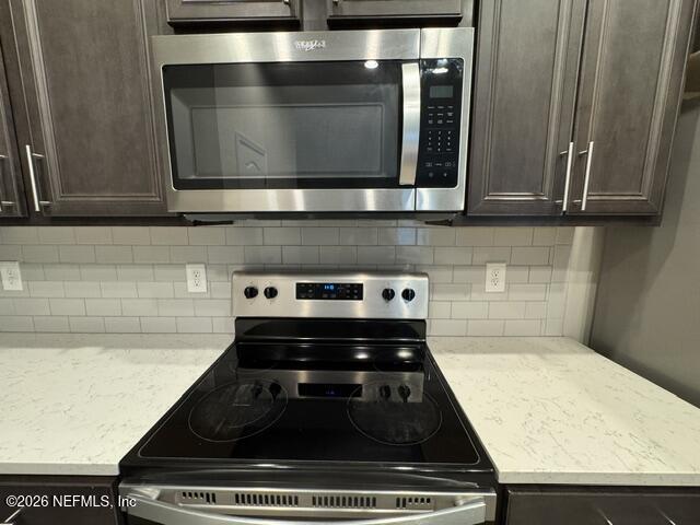 7816 Island Fox Road Jacksonville, FL 32222 - Photo 5 of 16 a stove top oven sitting inside of a kitchen