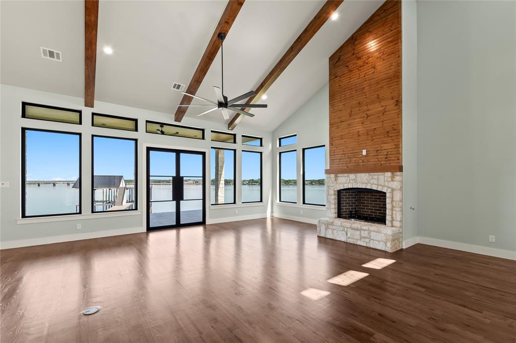 4054 Smothers Road Caney City, TX 75148 - Photo 3 of 40 Stunning stone wood-burning fireplace. Natural light pours through expansive lakeside windows.