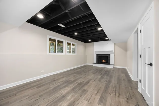 a living room with furniture fireplace and wooden floor