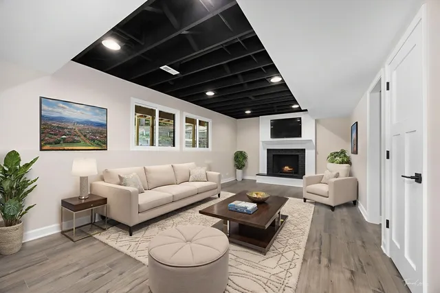 an empty room with wooden floor and window