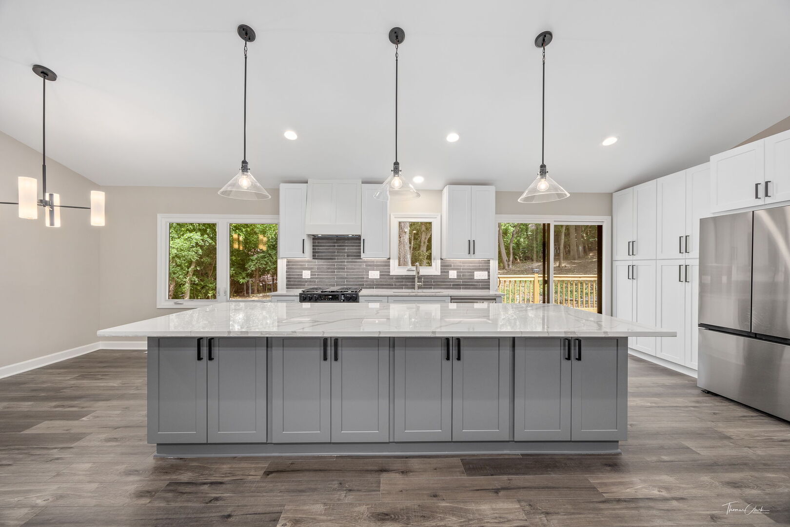9704 Captains Drive Algonquin, IL 60102 - Photo 4 of 35 a kitchen with stainless steel appliances kitchen island granite countertop a sink a refrigerator a stove a kitchen island and chairs with wooden floor